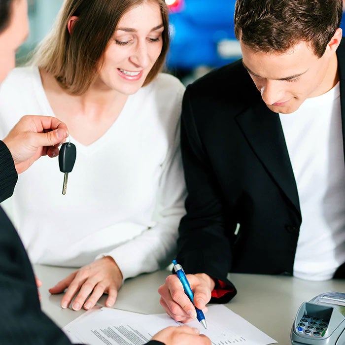 Couple signing finance contract at Sheboygan Auto Group in Sheboygan WI